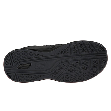Bottom view of a black New Balance WW813BK walking shoe showing its detailed tread pattern and sole design.