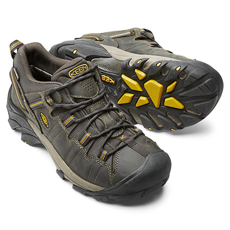 A pair of Keen Targhee II WP Ravin hiking shoes with gray and yellow accents, featuring a rugged, aggressive outsole design, isolated on a white background.