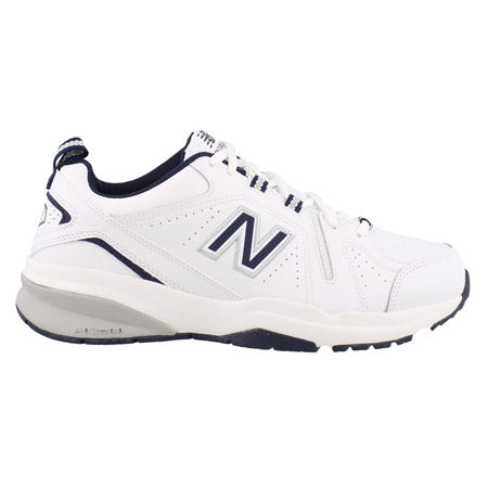 Side view of a white New Balance X608v5 sneaker with navy blue accents and the logo visible.
