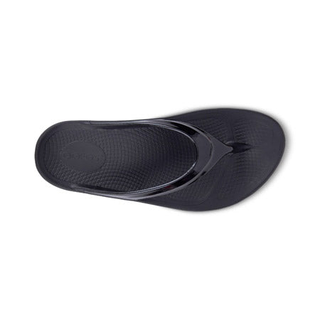 A single OOFOS OOlala Black - Womens flip-flop sandal featuring OOfoamTM technology displayed on a white background.