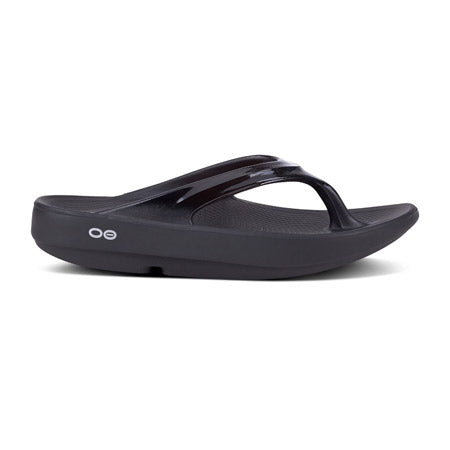 Oofos Oolala Black flip-flop with a thick sole featuring OOfoamTM technology and a glossy strap, displayed on a white background.