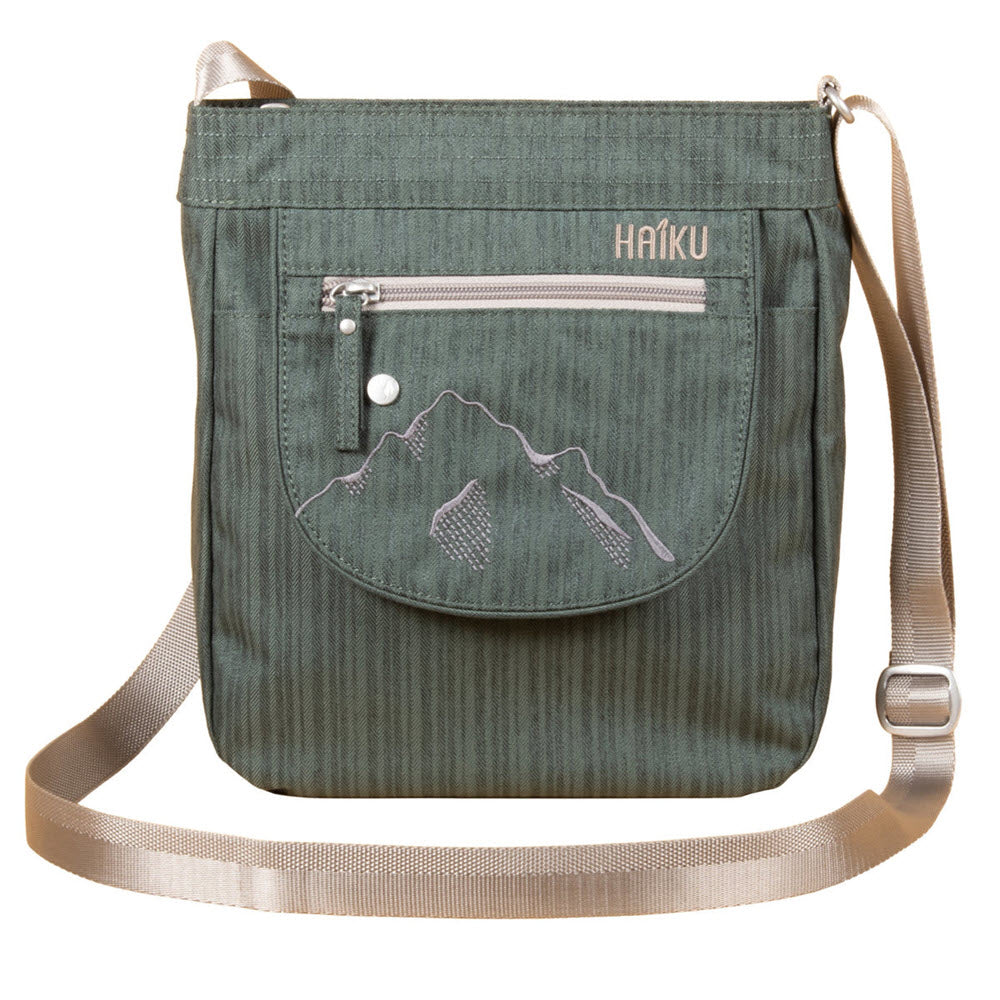 Haiku olive green messenger bag with a mountain design stitched on the front, featuring exterior zip pockets and an adjustable strap.