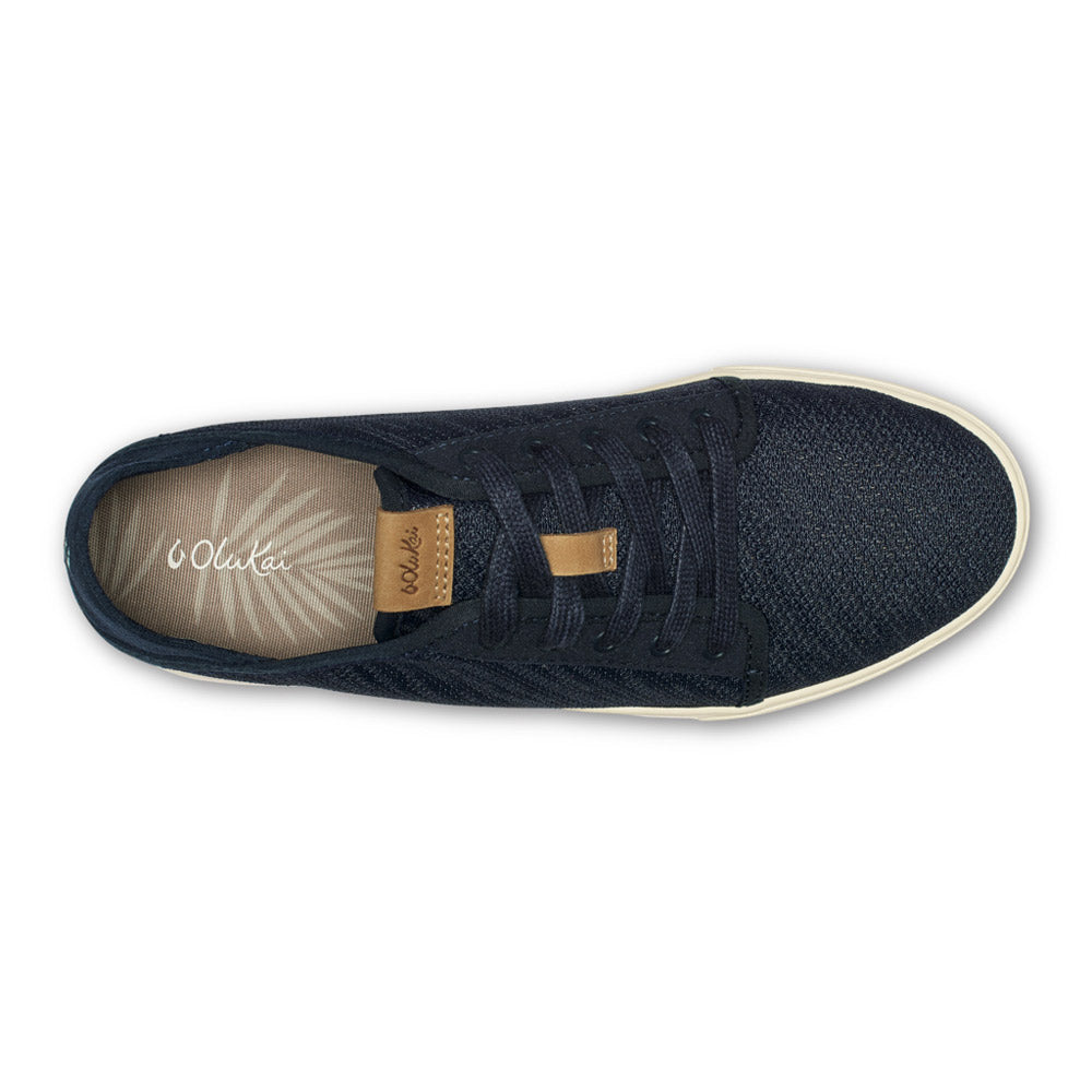 Top view of a single navy blue Olukai Pehuea Li sneaker with dark laces on a white background.