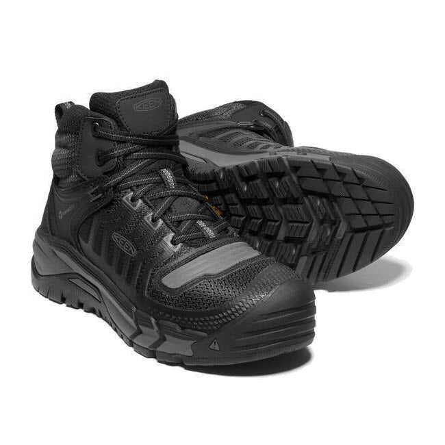 A pair of black Keen Kansas City Mid Safety Toe work boots with mesh inserts and robust rubber soles.