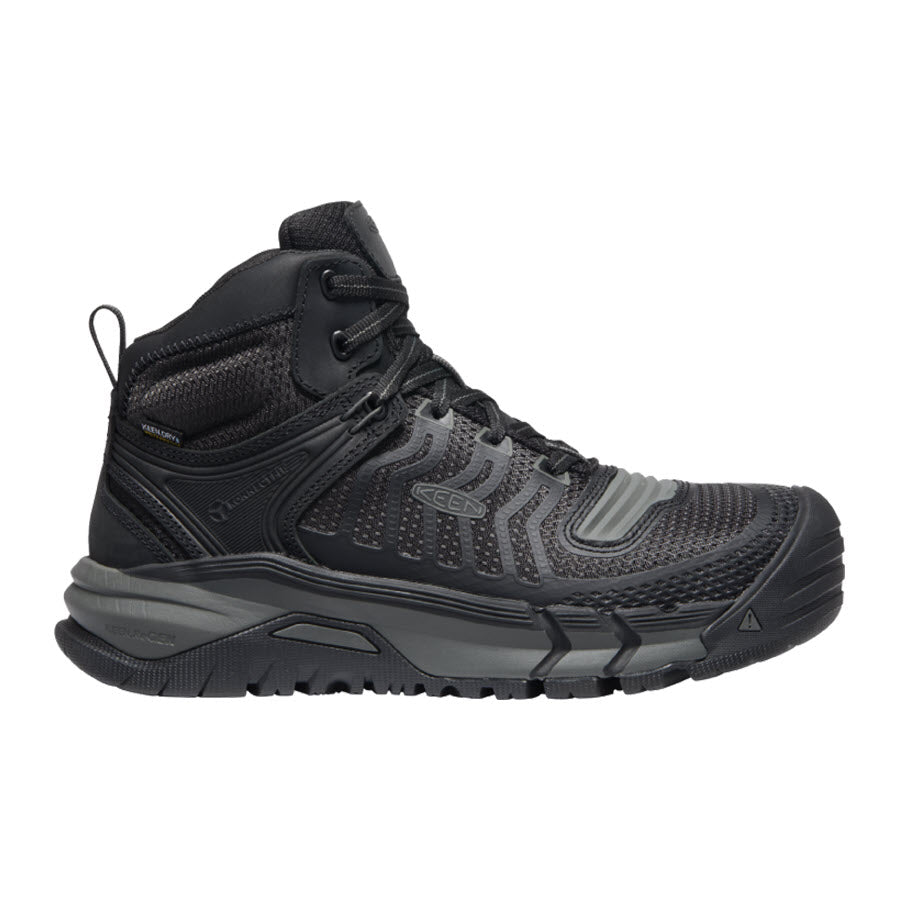 A Keen Kansas City Mid Safety Toe Black - Mens high-top hiking boot with a robust design, featuring a textured sole and reinforced composite-toe, suitable for rugged terrain.