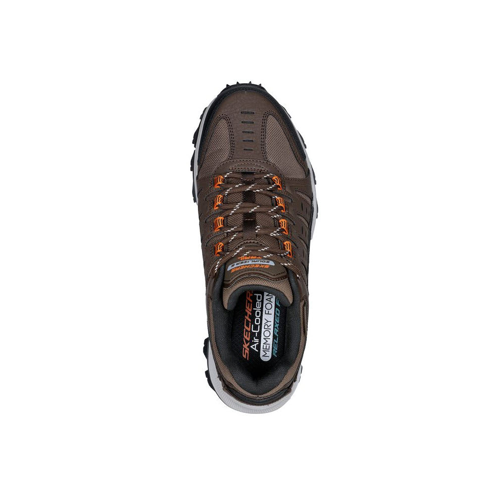 Top view of a Skechers Equalizer 5.0 Trail brown/orange shoe with visible brand logos, displayed on a white background.