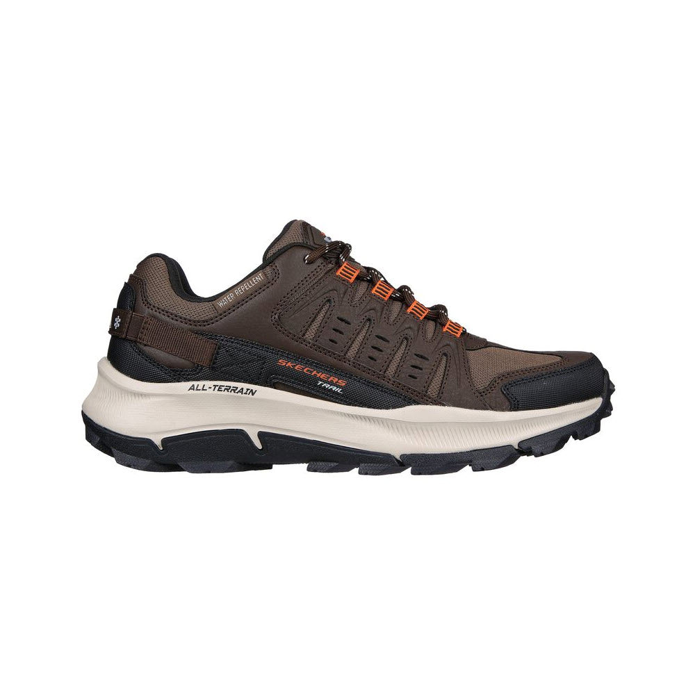 A brown all-terrain hiking shoe with white and black soles, and orange accents, displayed against a white background. Now featuring Skechers Air-Cooled Memory Foam for enhanced comfort. Now featuring SKECHERS EQUALIZER 5.0 TRAIL BROWN/ORANGE - MENS by Skechers.