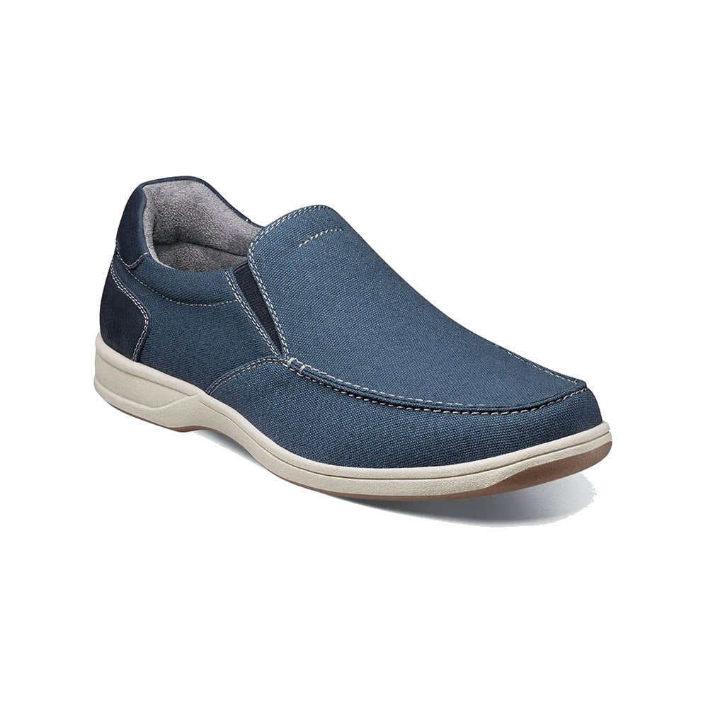 A single Florsheim Lakeside slip on canvas navy shoe with white soles displayed on a white background.