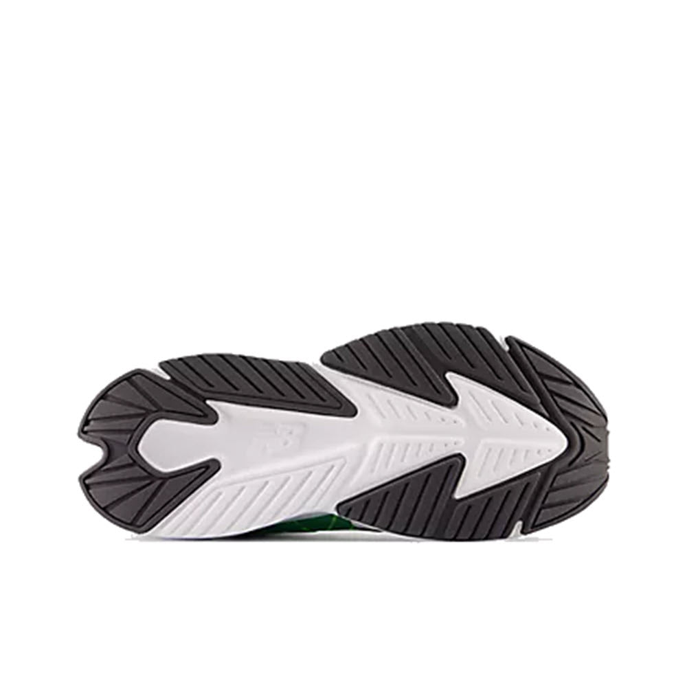 Bottom view of a New Balance kids&#39; running shoe with a white and black tread pattern, showcasing the durable rubber outsole design.