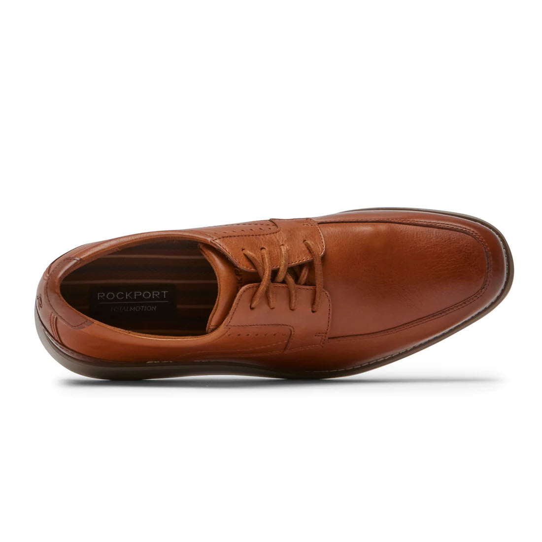 A single cognac leather Rockport Total Motion Craft apron toe oxford isolated on a white background, viewed from a top angle.