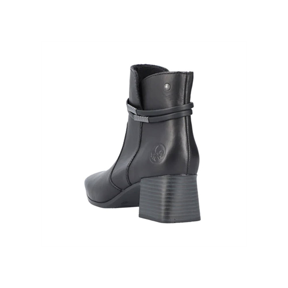 A Rieker RIEKER BLOCK HEEL DRESS BOOTIE BLACK LEATHER - WOMENS viewed from the back, showcasing a strap detail and an embossed logo, features cushioned anti-stress insoles for ultimate comfort.