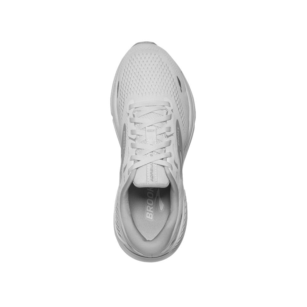 Top view of a single light gray Brooks Adrenaline GTS 23 white/oyster/silver women&#39;s running shoe with white laces and the brand name &quot;Brooks&quot; visible on the tongue.
