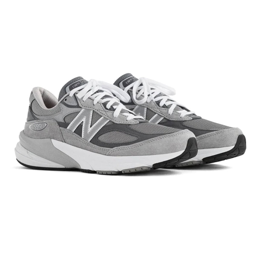 A pair of New Balance 990 V6 Grey running shoes, showing the side profile with white laces and the &quot;n&quot; logo visible.