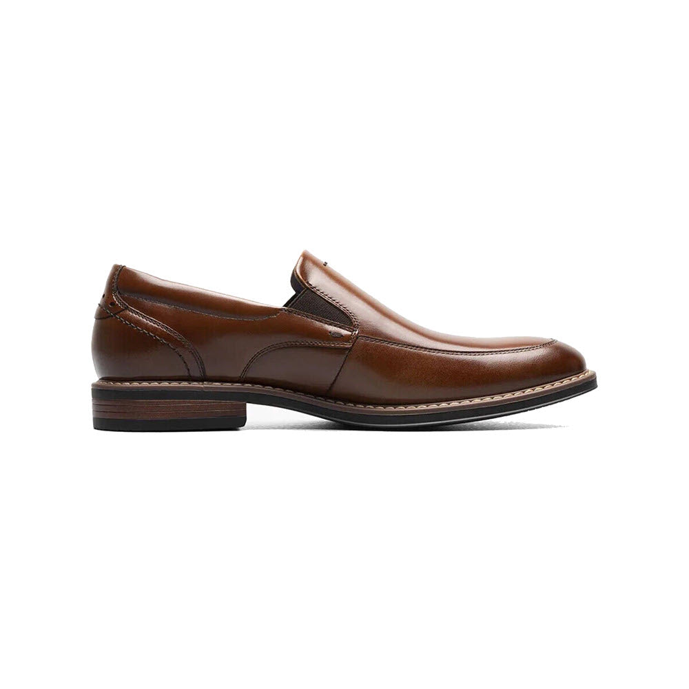 A single Nunn Bush Centro Flex moc toe Venetian cognac loafer with a low heel and white stitching, displayed against a white background. This model features Softgel heel pod for added comfort.