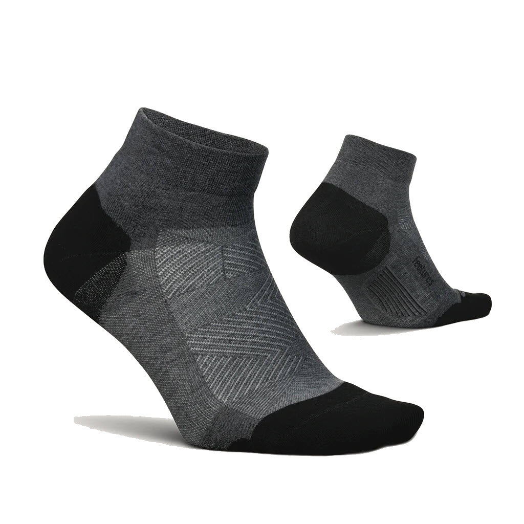 Two gray and black Feetures Elite Max Low Cut socks displayed against a white background.