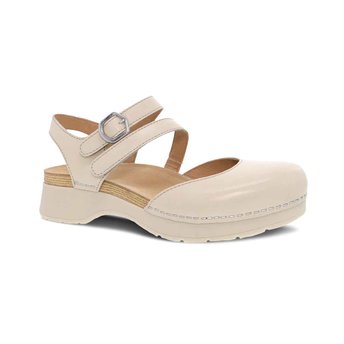 A single ivory Dansko Rissa mary jane style shoe with a closed toe, buckle strap, and chunky sole, displayed on a white background.