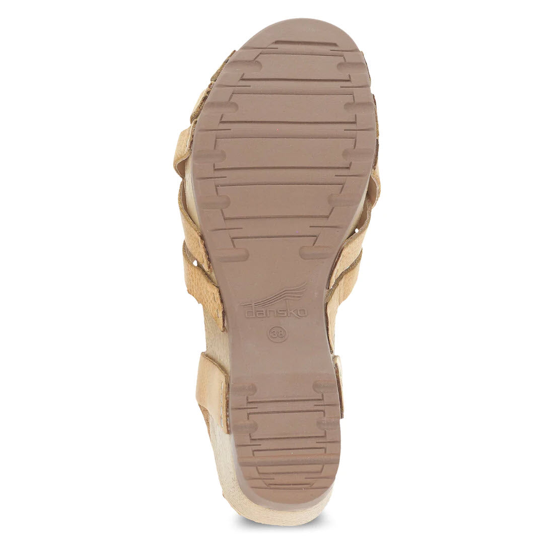 Bottom view of a beige Dansko sandal showing a textured rubber sole with a logo imprint, perfect as a summer staple.
