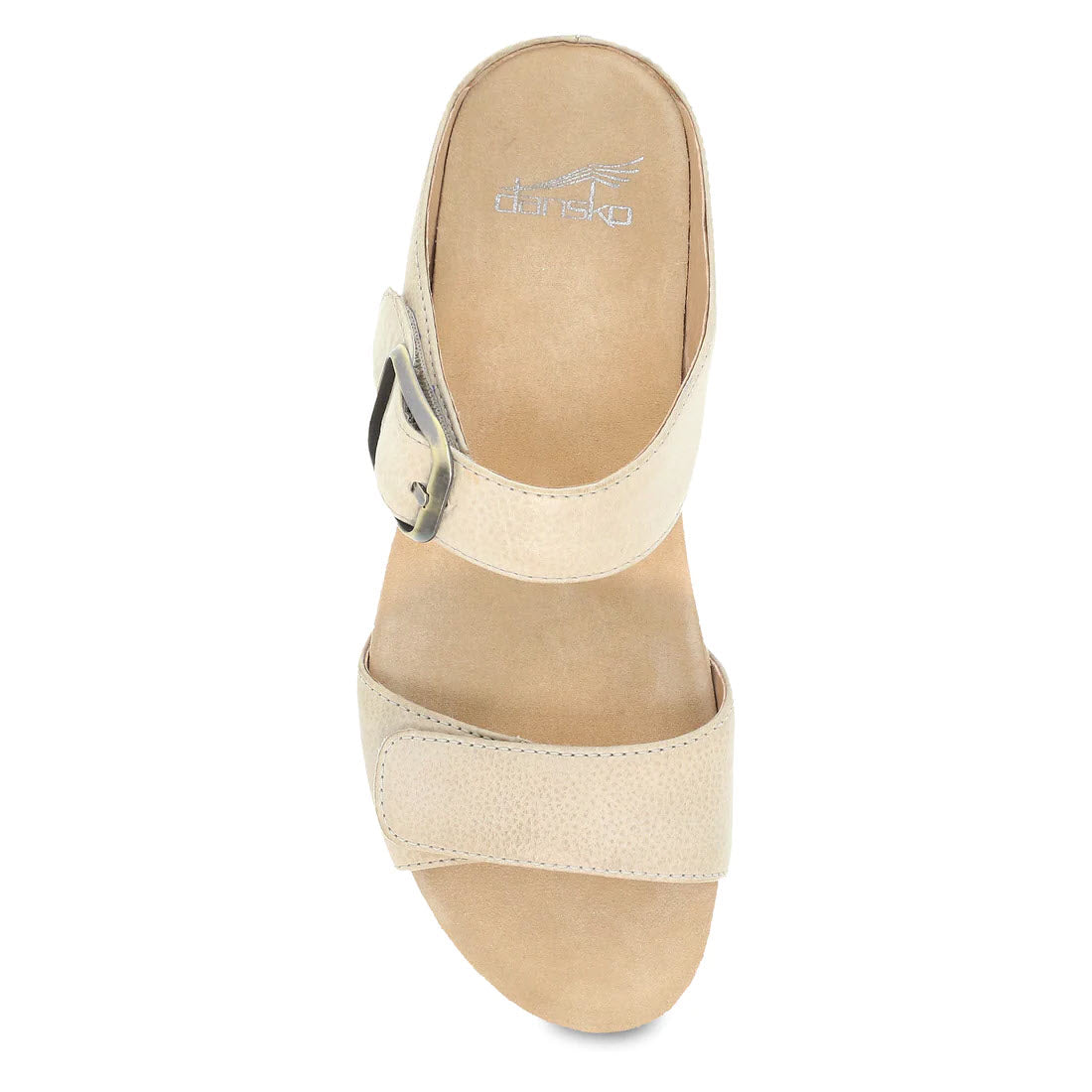 Top view of a beige Dansko Tanya Linen slide sandal with an adjustable strap and a round buckle, displaying the brand name on the insole.