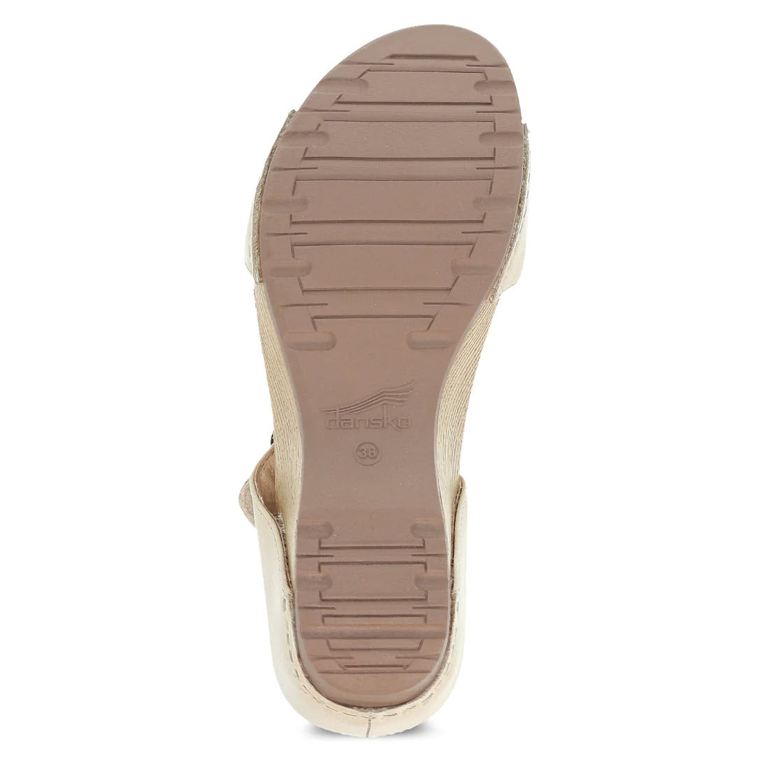 Beige slide sandal with a strap, viewed from the bottom showing a textured rubber outsole with Dansko logo imprint.