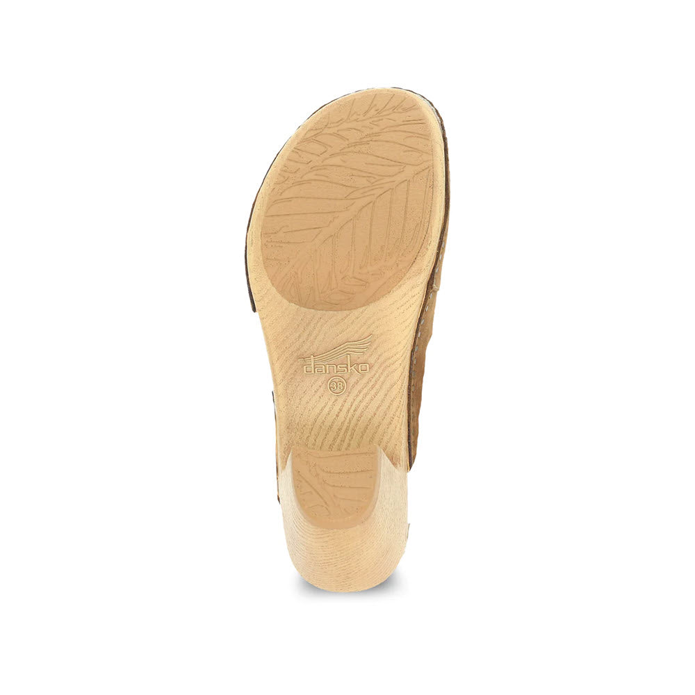 A single Dansko Taytum Tan closed-toe shoe sole with visible tread patterns and branding.
