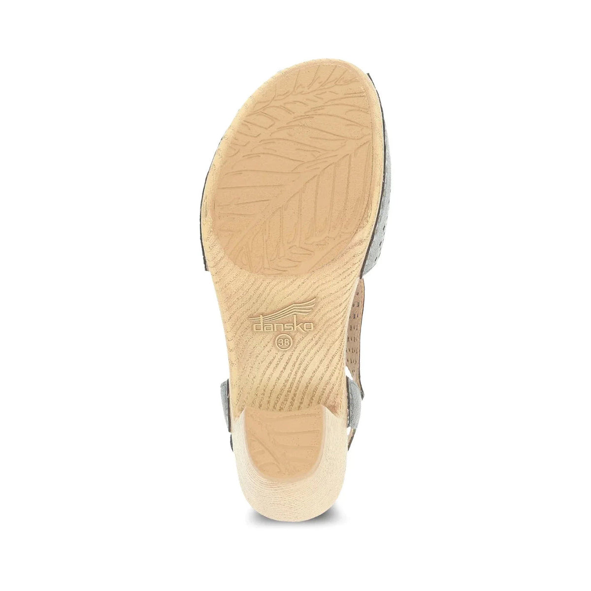 Bottom view of a beige Dansko Teagan Gunmetal Metallic clog showing the textured sole with a leaf pattern and embossed brand logo, featuring a cushioned polyurethane footbed.