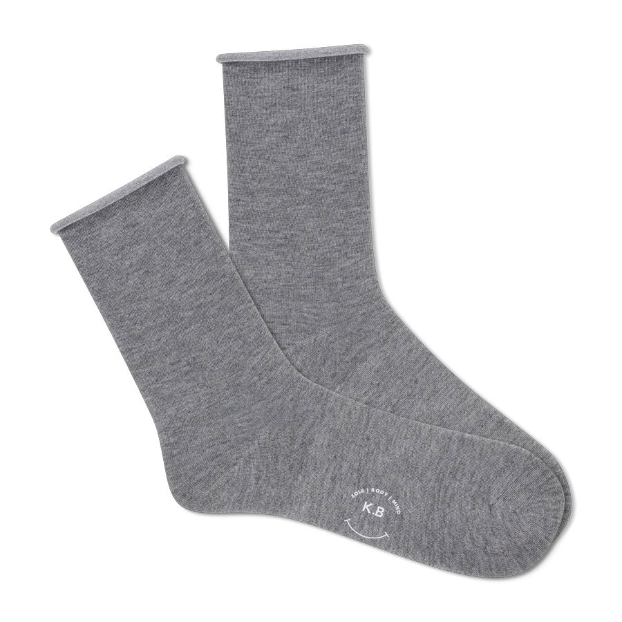 A pair of comfortable K. Bell Socks solid modal roll top charcoal socks lying flat on a white background, with a small logo printed on the sole of one sock.