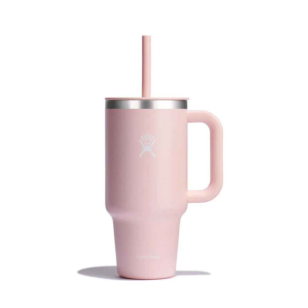 A pink Hydro Flask 32oz travel tumbler with a durable handle and a straw, isolated on a white background.