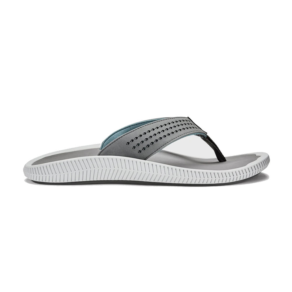 A single Olukai Ulule Flip Flop Stone - Mens with a gray and teal strap over a white sole, displayed against a white background.