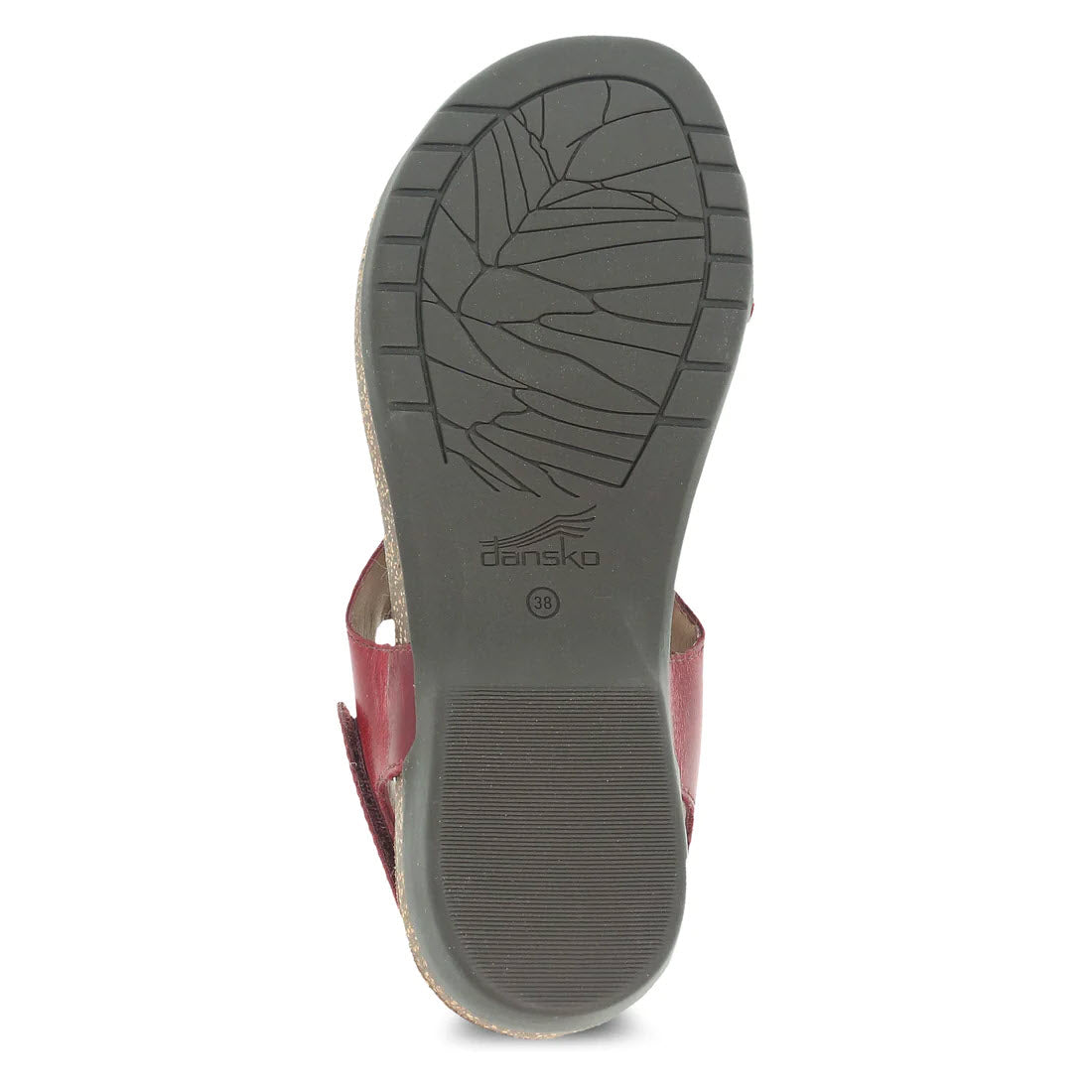 Sole of a red Dansko Reece Cinnabar shoe showing tread pattern and brand logo with leather linings.