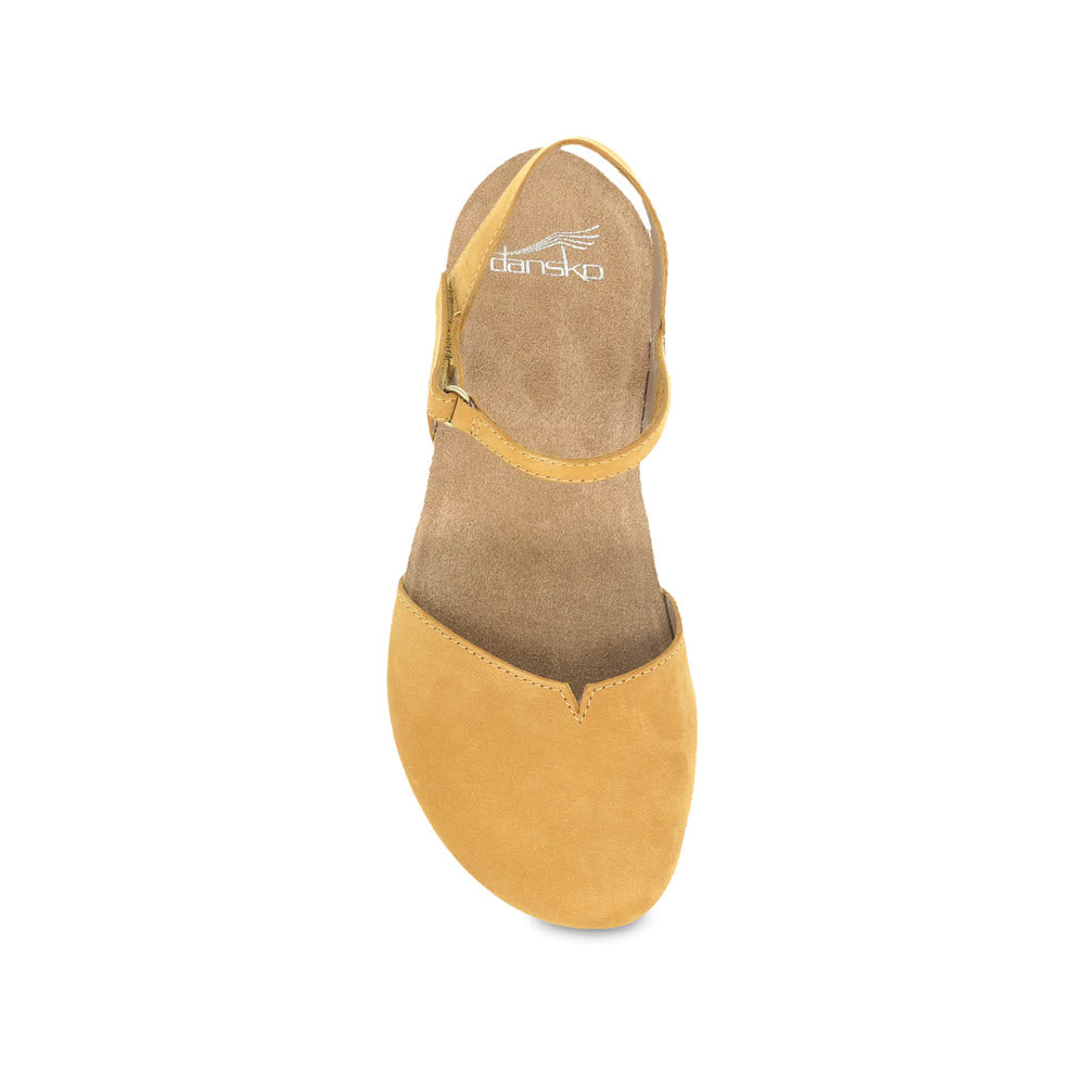 Top view of a tan suede Dansko Rowan Mustard summer sandal with an ankle strap on a white background.