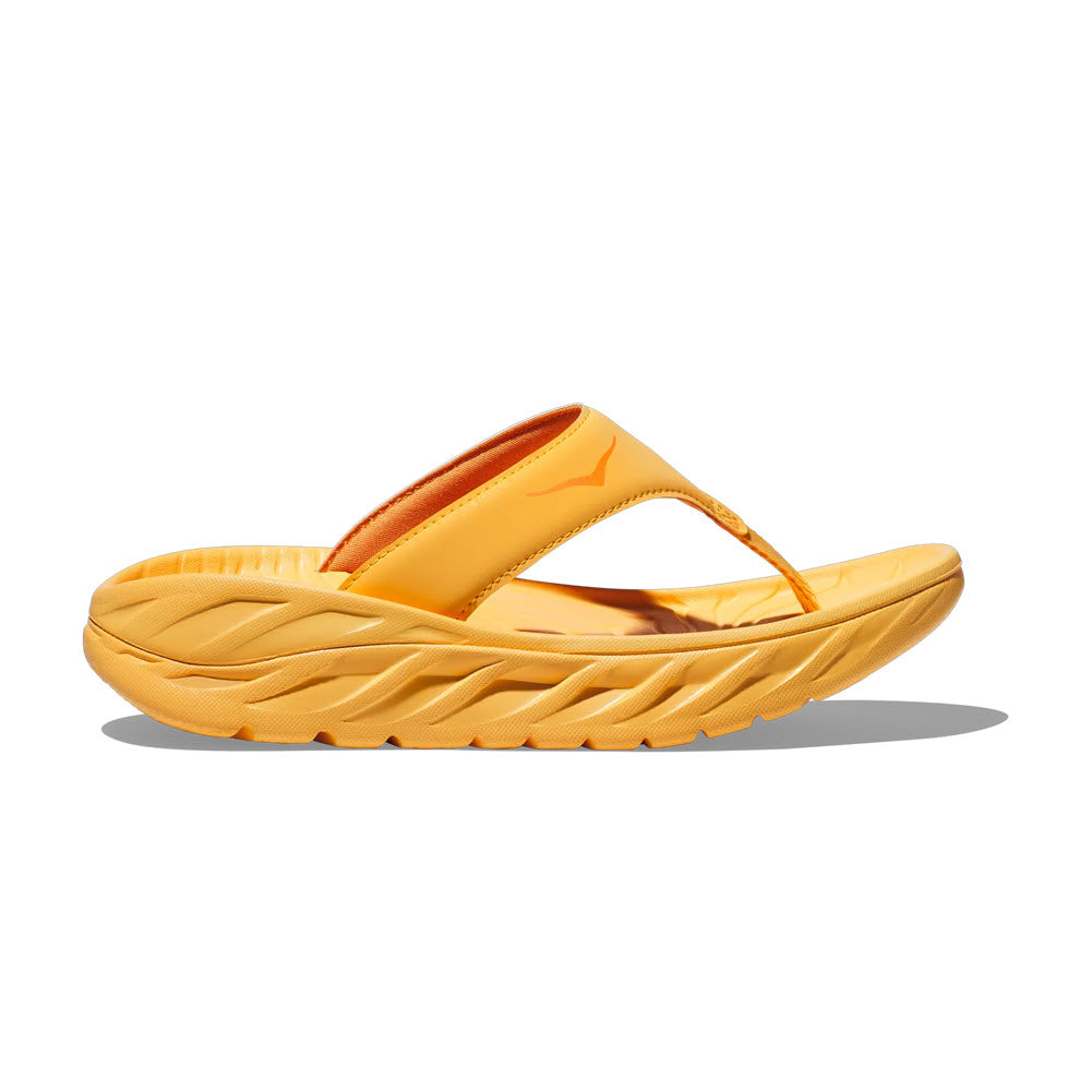 Bright yellow Hoka Ora Recovery Flip Wistful Poppy/Squash sandal with an oversized midsole and a glossy finish, displayed against a white background.