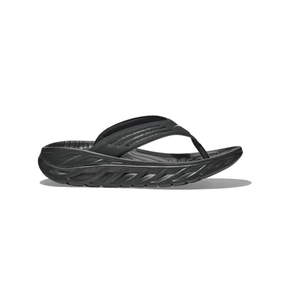 A single black HOKA ORA RECOVERY FLIP with textured sole and straps, isolated on a white background.