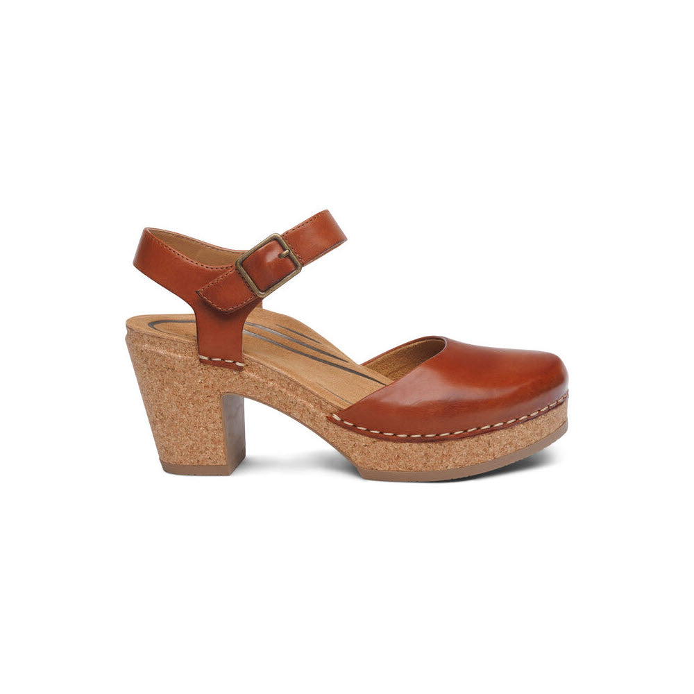 A Aetrex Finley Cognac women's leather clog with a high cork heel and a buckle strap, featuring memory foam cushioning, isolated on a white background.