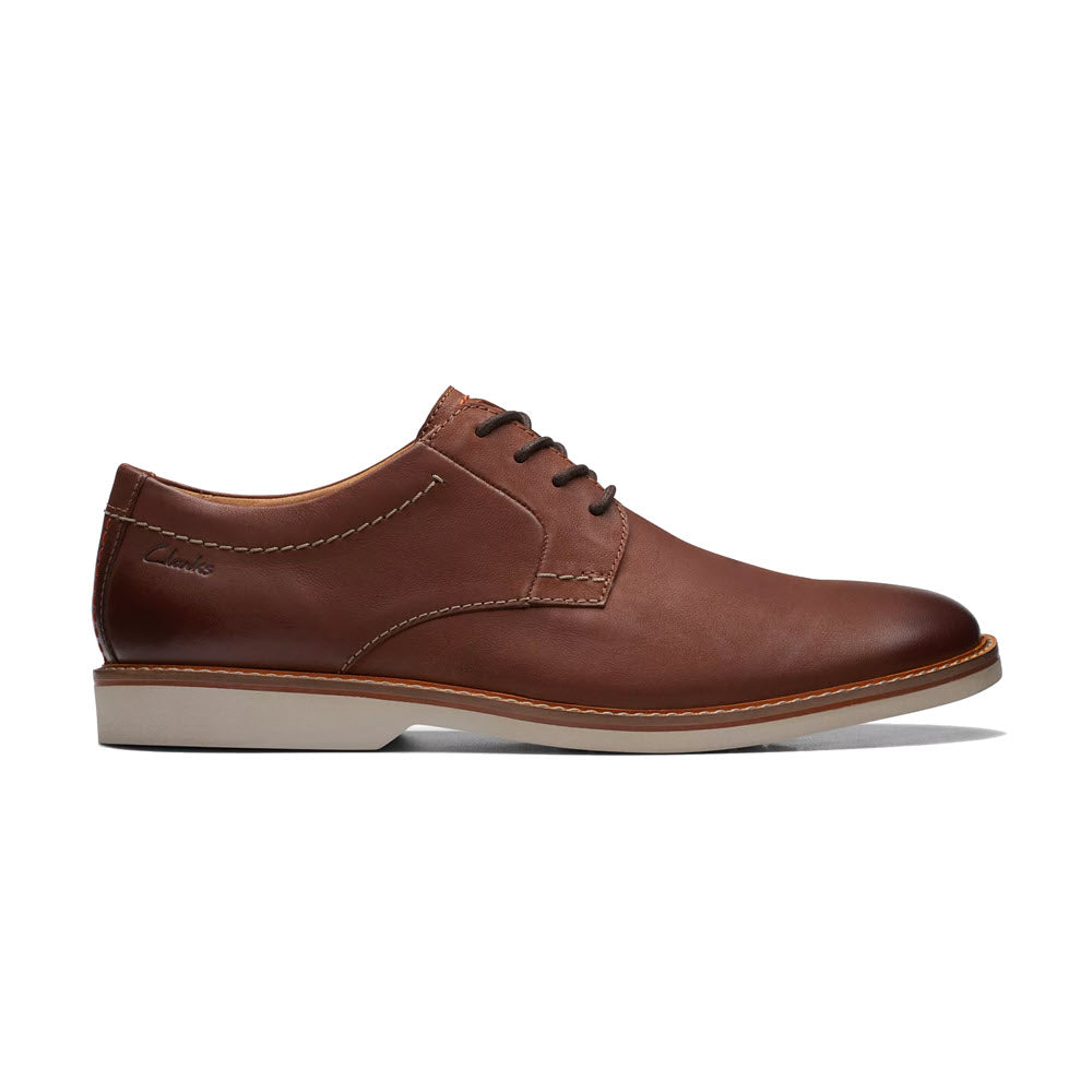 Brown leather Clarks Atticus LT Lace Oxford dress shoe with stylish laces on a white background.