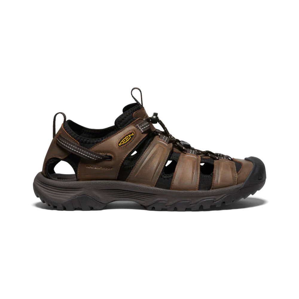 Side view of a brown waterproof leather Keen Targhee III sandal with multiple straps and a thick black sole, isolated on a white background.