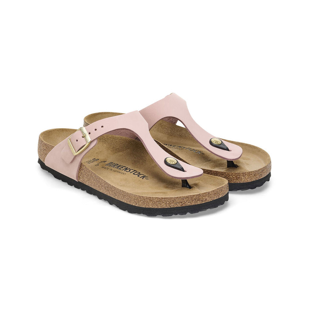 A pair of Birkenstock Gizeh Soft Pink sandals with pink nubuck leather straps and cork soles, displayed against a white background.