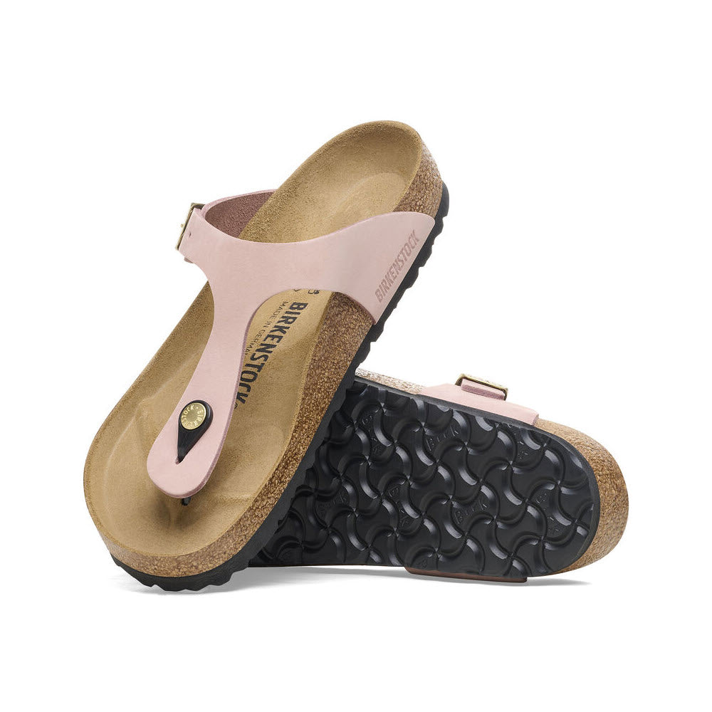 A pair of pink Birkenstock Gizeh Soft Pink sandals with an anatomically shaped cork-latex footbed and a black EVA sole, displayed against a white background.
