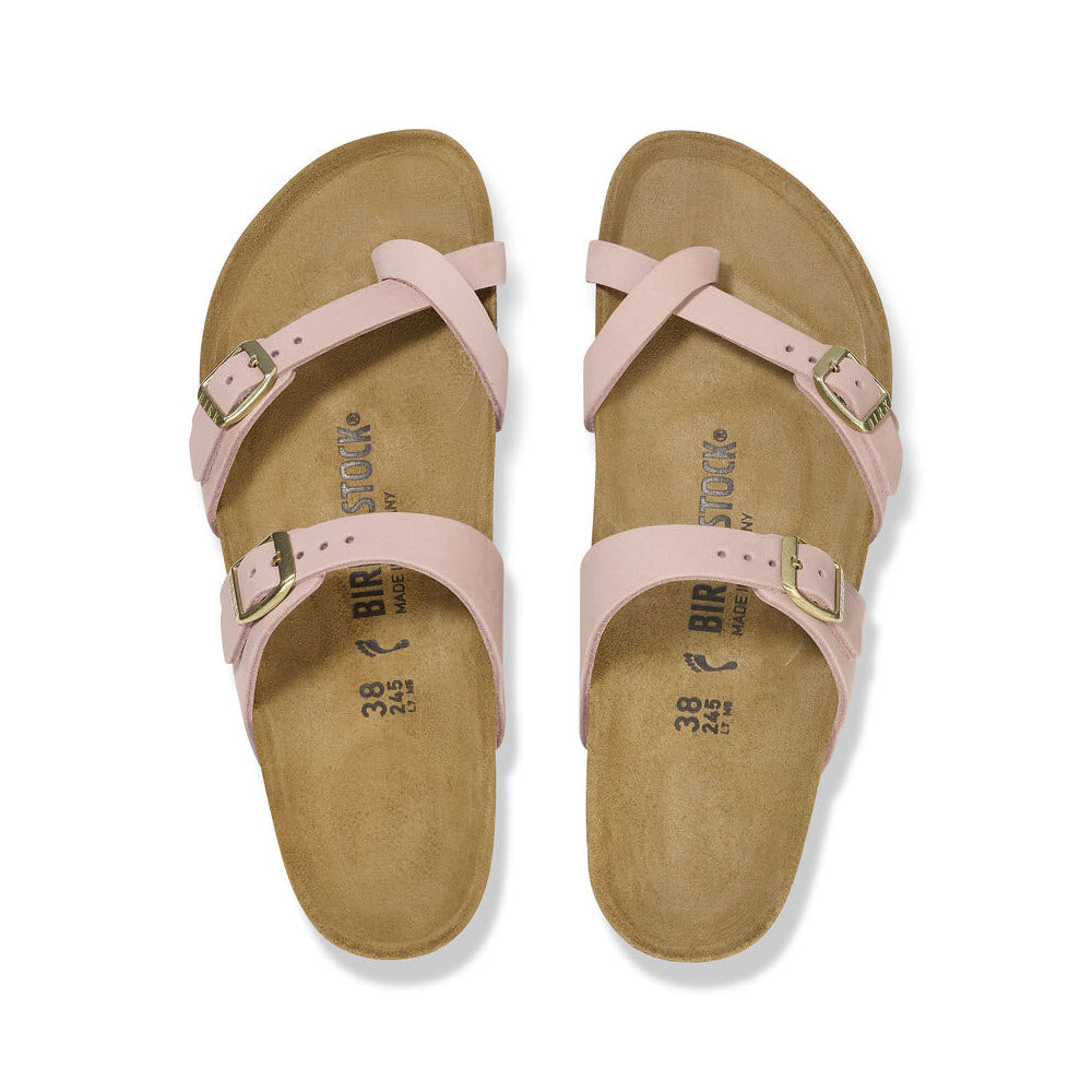 A pair of pink Birkenstock Mayari Soft Pink - Womens sandals with buckles on a cork-latex footbed, viewed from above on a white background.