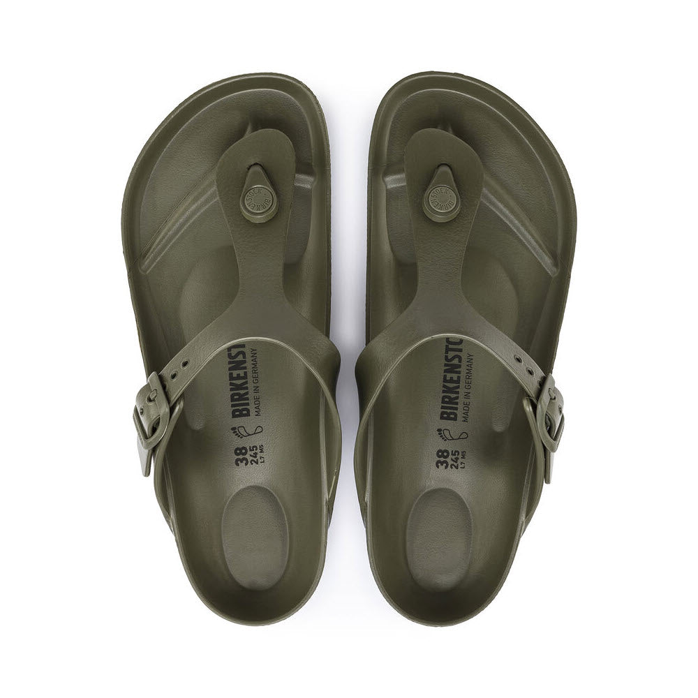 A pair of olive green Birkenstock Gizeh EVA sandals with buckle straps viewed from above on a white background.