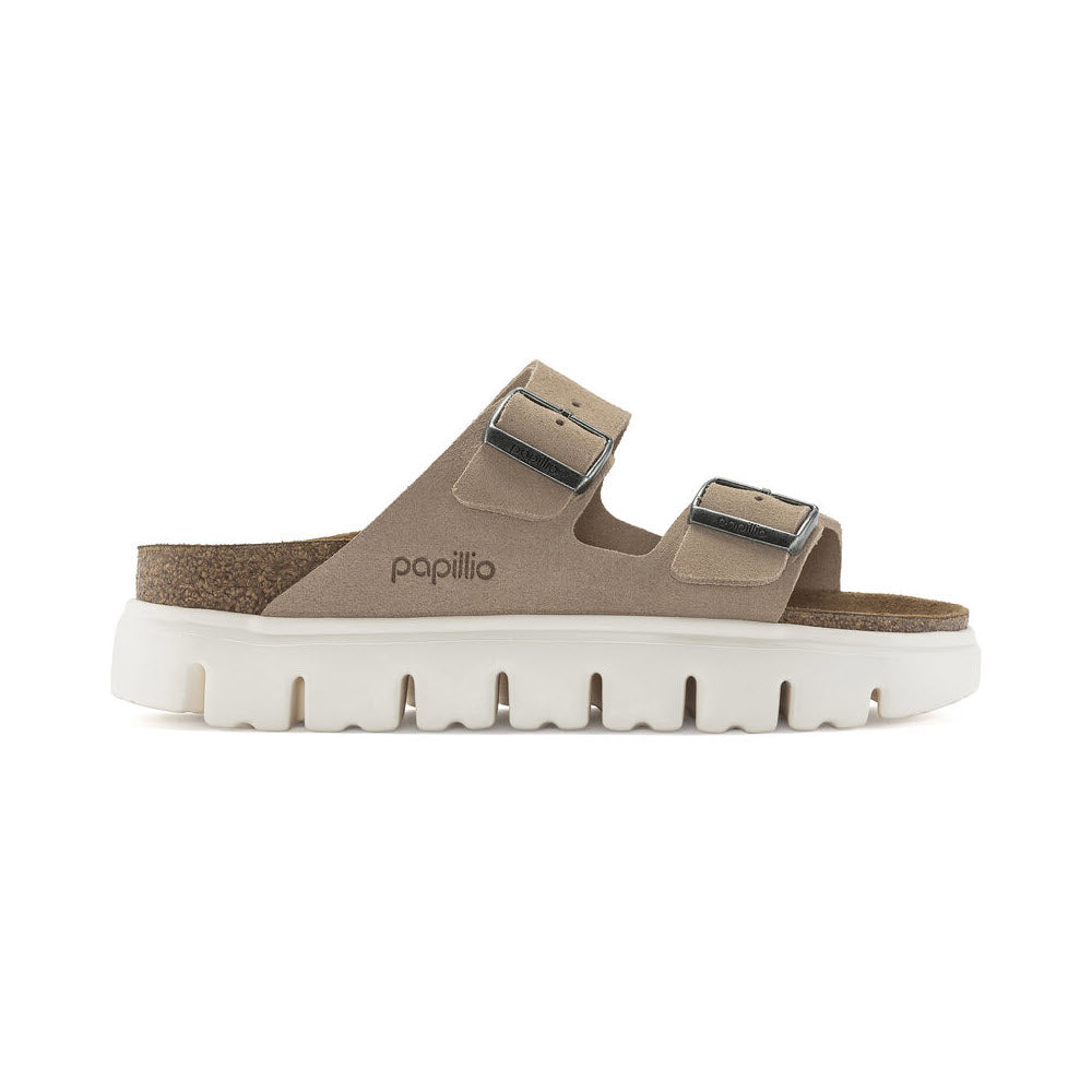 A pair of beige Birkenstock Arizona Chunky Warm Sand sandals with double straps and a platform sole, isolated on a white background.