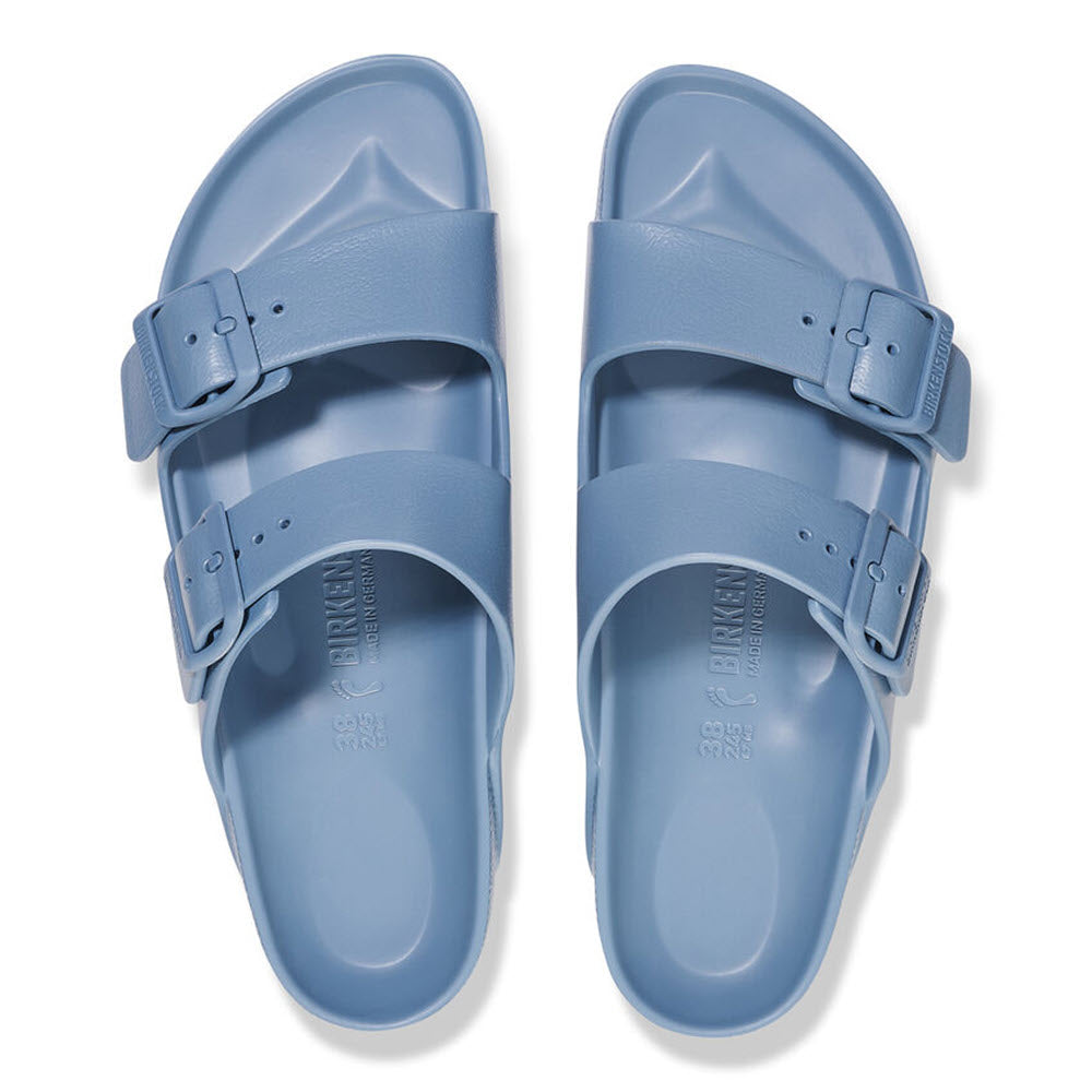 A pair of light blue Birkenstock Arizona EVA Elemental Blue sandals displayed from above on a white background.