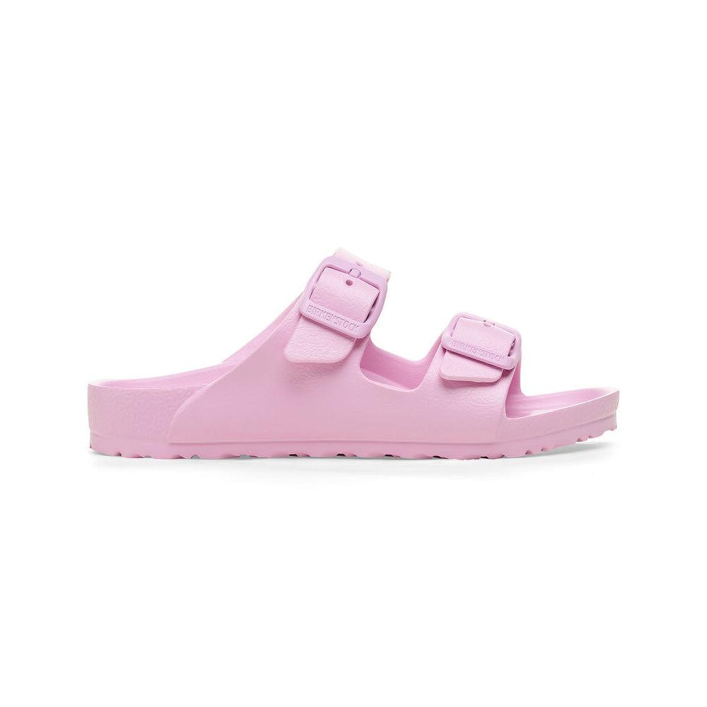 A pair of pastel pink Birkenstock Arizona EVA Fondant Pink slide sandals with adjustable buckles, isolated on a white background.