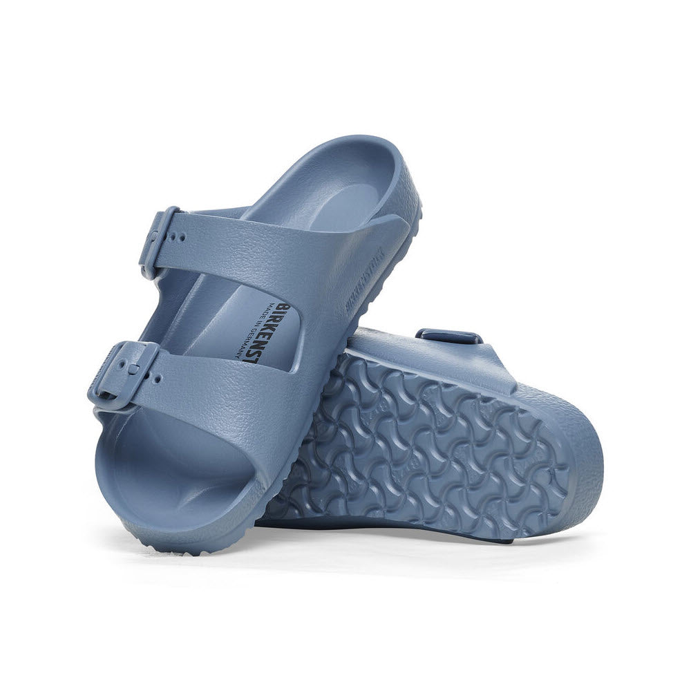 A pair of Birkenstock Arizona Eva Elemental Blue - Kids sandals with a textured sole and buckle detail, isolated on a white background.