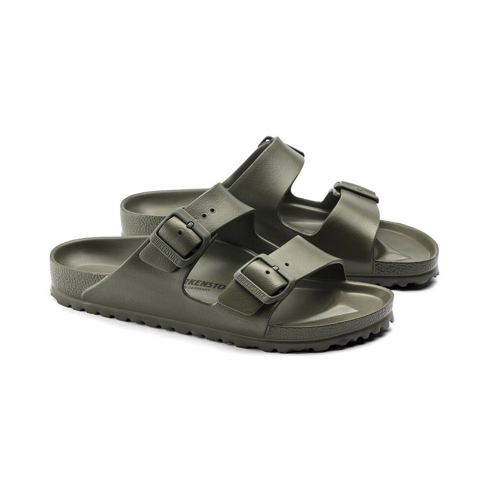 A pair of olive green Birkenstock Arizona EVA Khaki sandals with adjustable straps and buckles, displayed against a white background.
