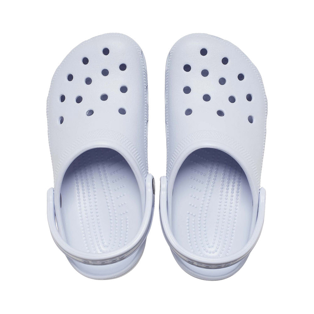 A pair of iconic Crocs Classic Clog Dreamscape, white rubber with straps and multiple ventilation holes, viewed from above, on a white background.