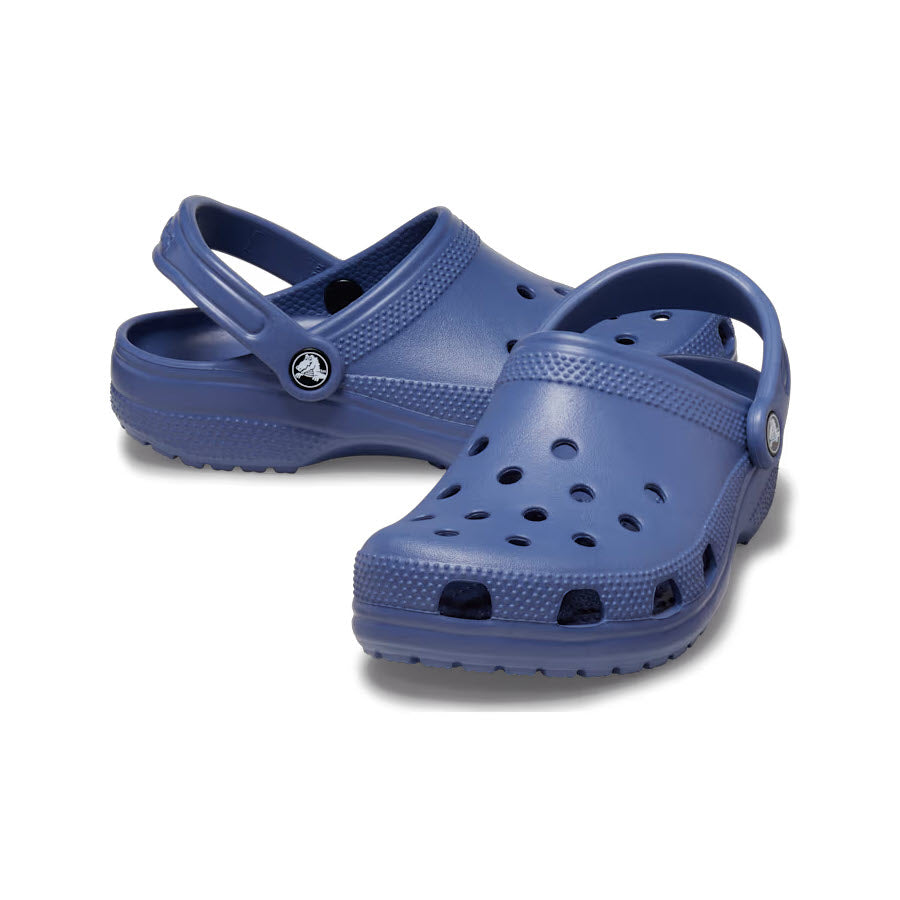 A pair of blue Crocs Classic Clogs on a white background.
