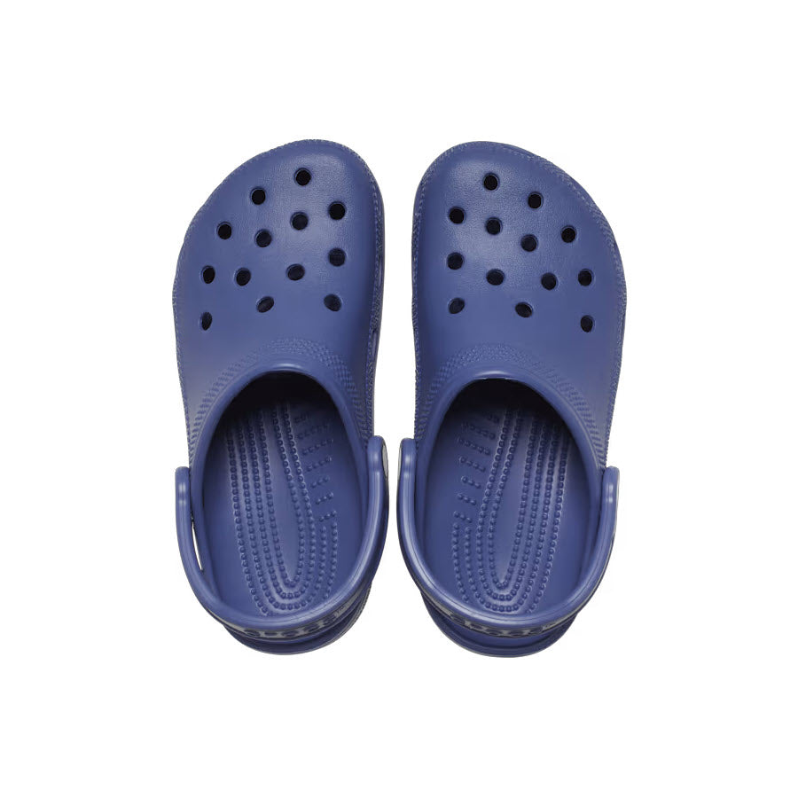 A pair of blue Crocs Classic Clogs with ventilation holes, viewed from above on a white background.