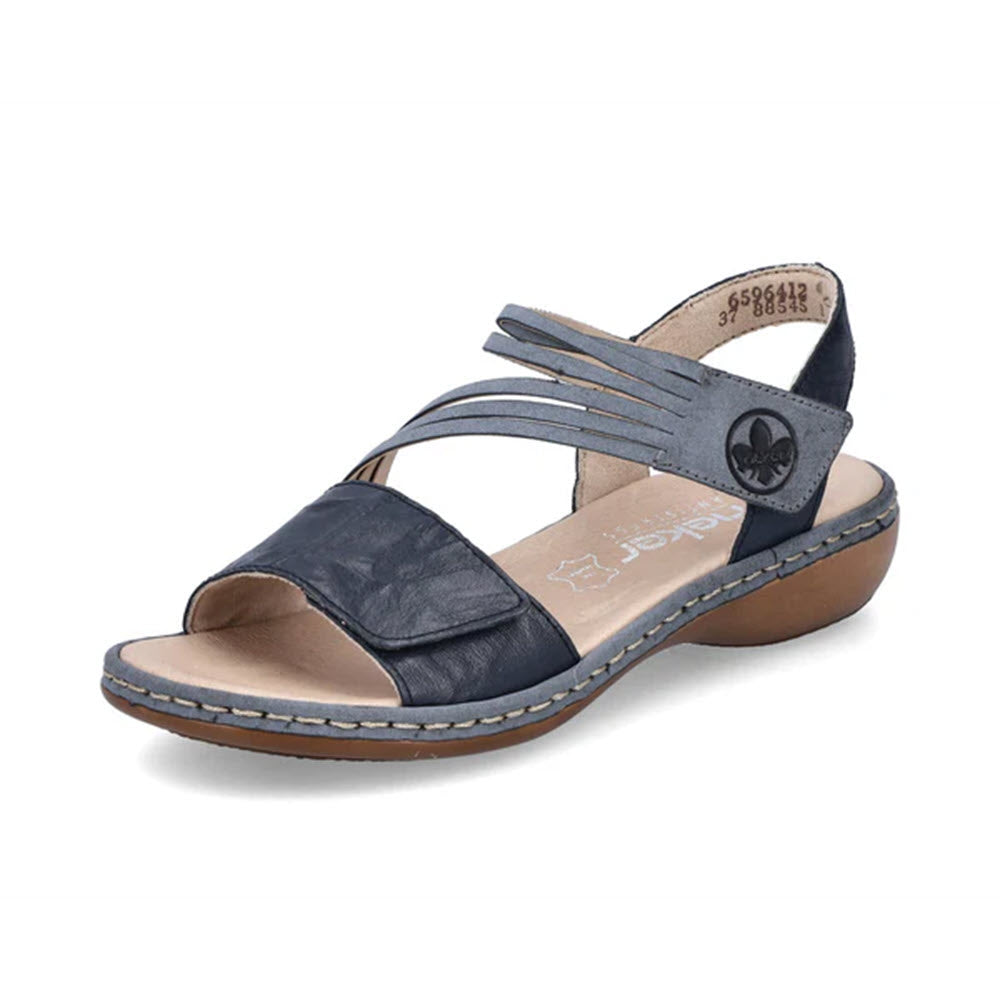 A Rieker navy blue women&#39;s strap sandal with an adjustable hook and loop fastener and a small heel, featuring a jeep logo on the ankle strap.