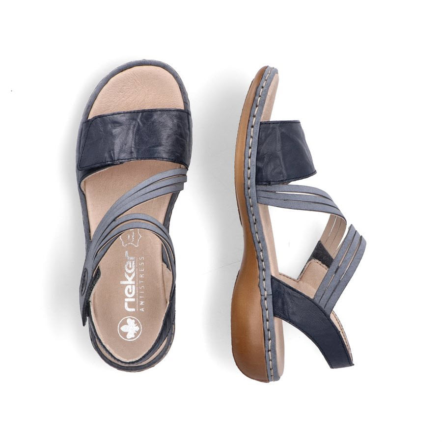 A pair of navy blue Rieker Comfort Bottom Asymmetrical Sandals - Women&#39;s with a low heel and crisscross straps, viewed from above on a white background.