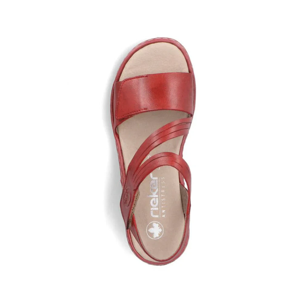 A top view of a single Rieker red leather sandal with an adjustable hook and loop fastener on a white background.